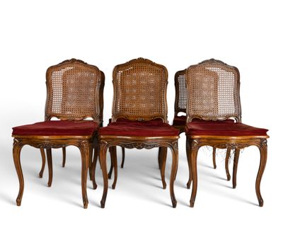 four chairs with red cushions and cane back cushions