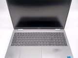 an open laptop computer sitting on top of a white table