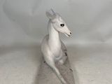 a small statue of a horse that is sitting on top of a table