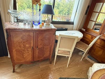 a wooden cabinet with a mirror on top of it in a living room