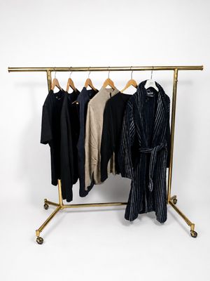clothes hanging on a clothes rack on a white background