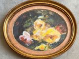 painting of a painting of flowers in a gold frame on a table