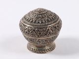a small silver box with a lid on a white surface