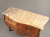 an antique chest of drawers with a marble top on a stand