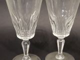 two clear wine glasses sitting on top of a black table