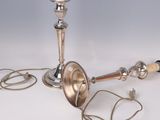 a silver candle that is on a table with a cord