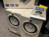 two speakers sitting on top of each other on the floor