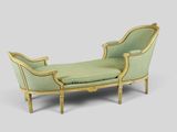 a green chaise with a gold frame and a green cushion
