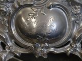 a silver plate with writing on it sitting on a table