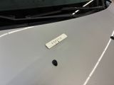 a sticker on the hood of a car that is parked in a garage