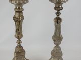 pair of antique silver candlesticks on stand on white background