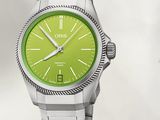 a picture of a watch with a green dial