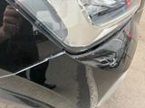 a man taking a picture of his reflection in the mirror of a car