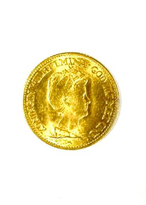 a close up of a gold coin on a white surface