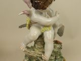 a figurine of a boy sitting on a rock