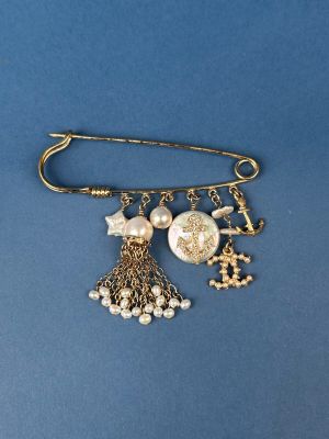 an image of a broocher with charms on it on a blue background