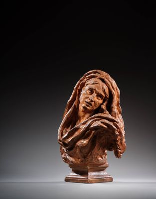 a carved bust of a woman with a veil on her head