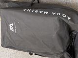 a bag that is sitting on the ground with it ' s contents