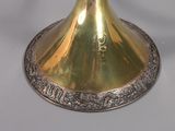 a gold candle holder on a white table