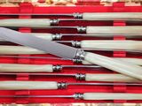 six knives in a box with a knife on top of it