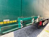 a green semi trailer with a red fire hydrant on the side of it
