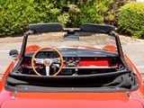 a red convertible car with a steering wheel and dashboard