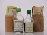 deux bouteilles d'alcool et un flacon de savon posés sur une table
