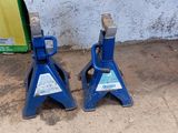 two blue jack stands on the ground next to each other
