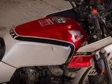 a red and white motorcycle parked in a parking lot