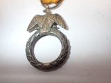a silver ring with an eagle on top of it