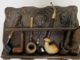 a shelf that has a bunch of pipes and pipes on it