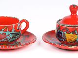 two cups and saucers sitting on a saucer