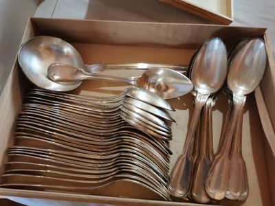 a lot of silver spoons and spoons in a box