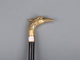 a close up of a walking stick with a bird head on it