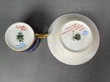 a cup and saucer sitting on a table next to each other