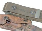a belt and a knife on a white surface