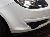 a close up of a white car parked in a garage