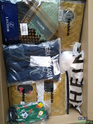 a cardboard box filled with many different types of clothing
