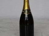 a bottle of champagne sitting on a marble table