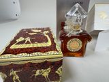 a bottle of perfume sitting next to a box on a table
