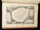 an old book with a map on it on a table