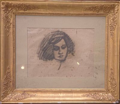 dessin représentant le visage d'une femme dans un cadre doré