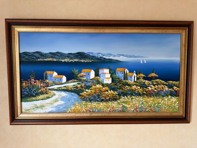a picture of a painting hanging on the wall above a bed