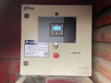 a machine that is sitting on the side of a building