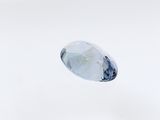 a close up of a white diamond on a white surface