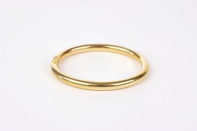 a gold ring on a white background