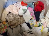a white box filled with clothes and a teddy bear