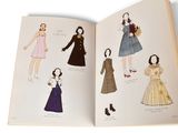 a book with a picture of women ' s fashions on it