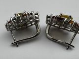 pair of silver tone cuff earrings with citrine stones