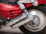 a close up of a red motorcycle parked on the street
